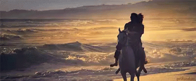 guy and girl galloping off on horse by sea gif – Supernatural Hippie